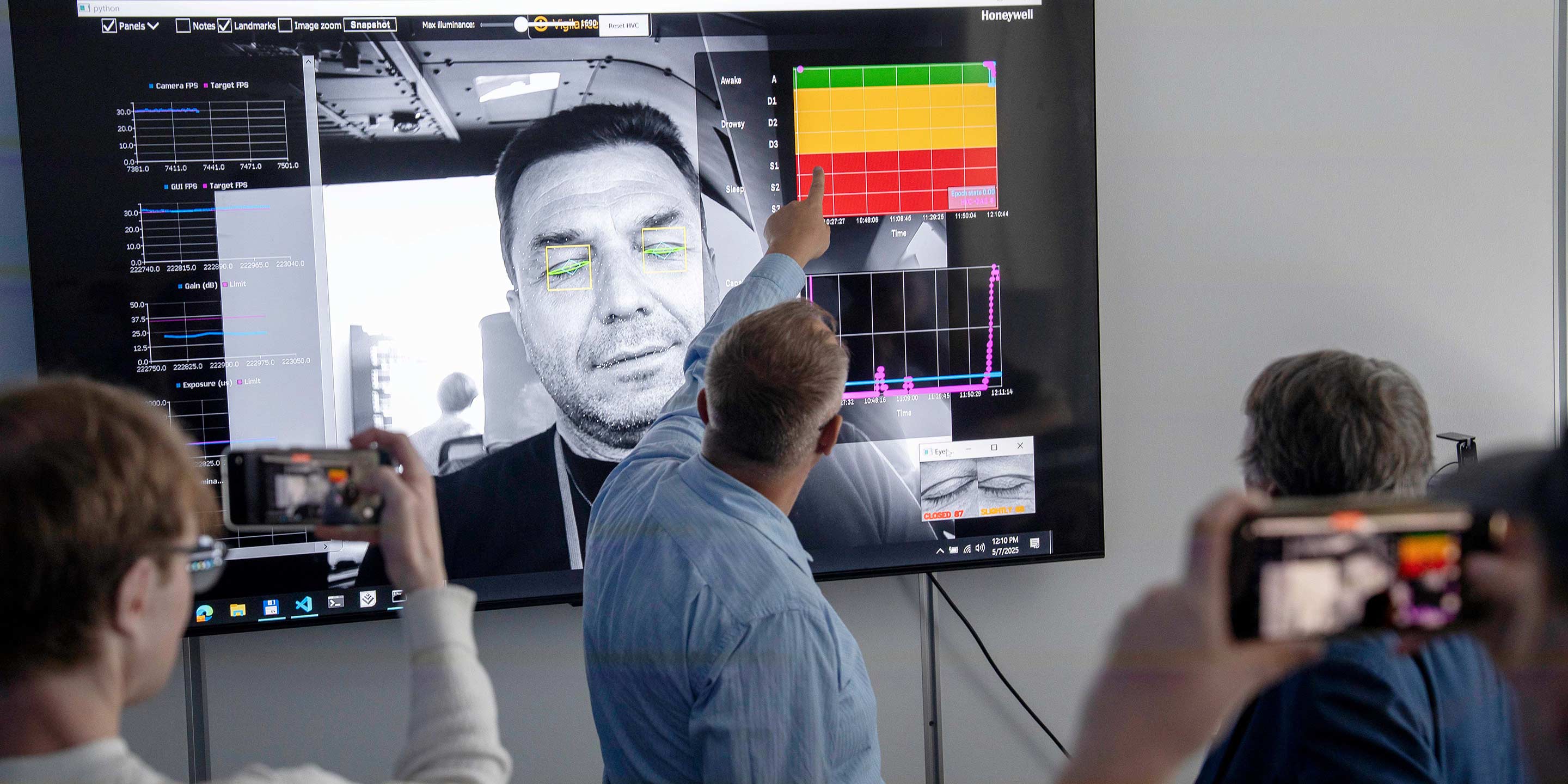 an image of an audience watching a man explaining Honeywell's pilot drowsiness detection technology